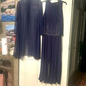 Navy dressy sleeveless jumpsuit with sheer jacket.